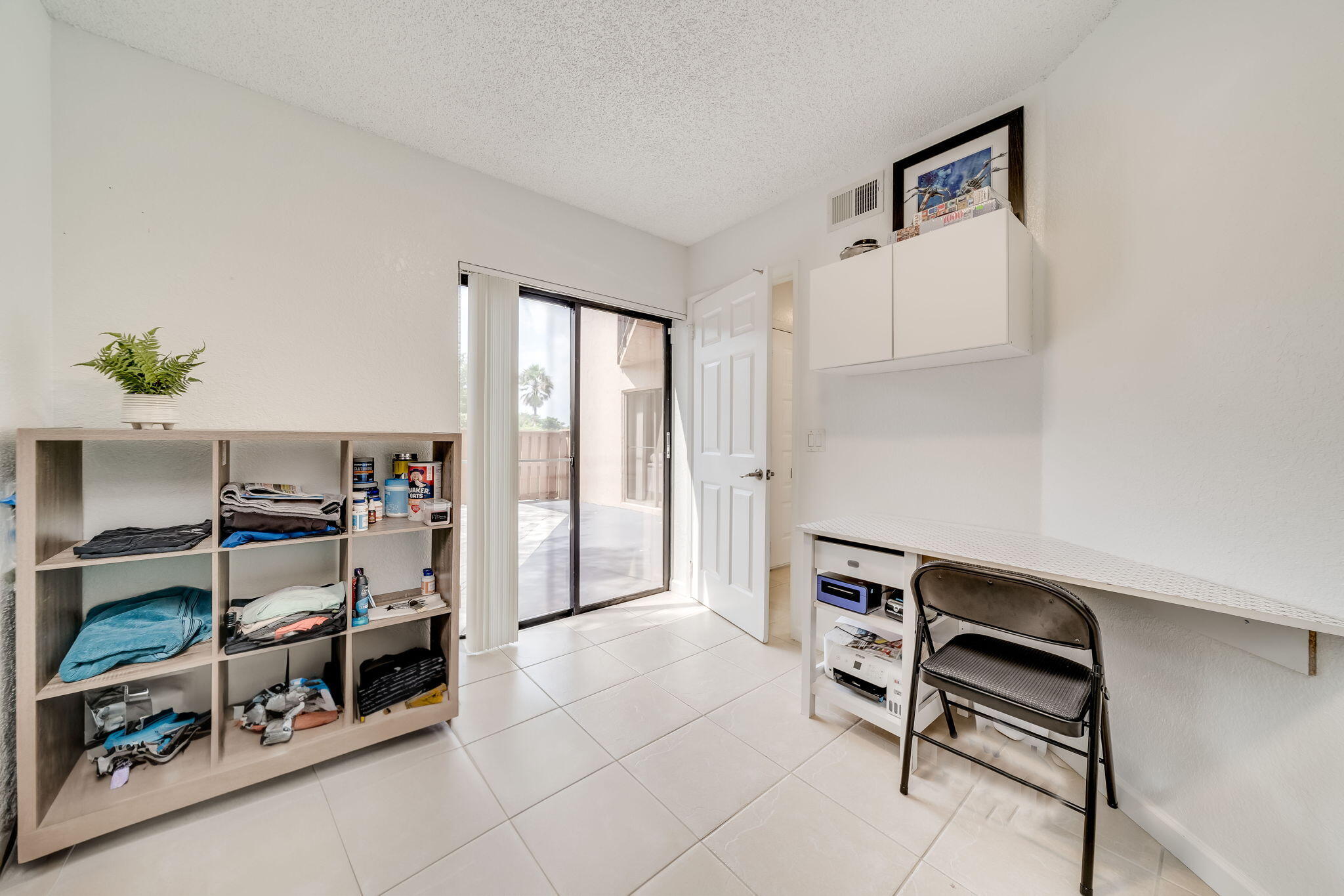 8116 Severn Drive, Unit C Boca Raton, FL 33433 - Photo 17 of 52 a view of workspace and bedroom with furniture