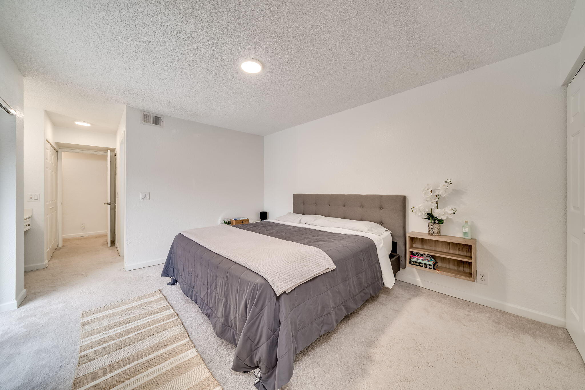 8116 Severn Drive, Unit C Boca Raton, FL 33433 - Photo 19 of 52 a bedroom with a bed and a lamp with window