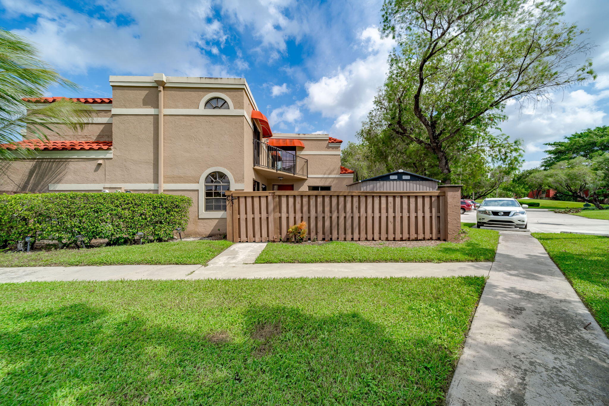 8116 Severn Drive, Unit C Boca Raton, FL 33433 - Photo 2 of 52 a front view of a house with garden