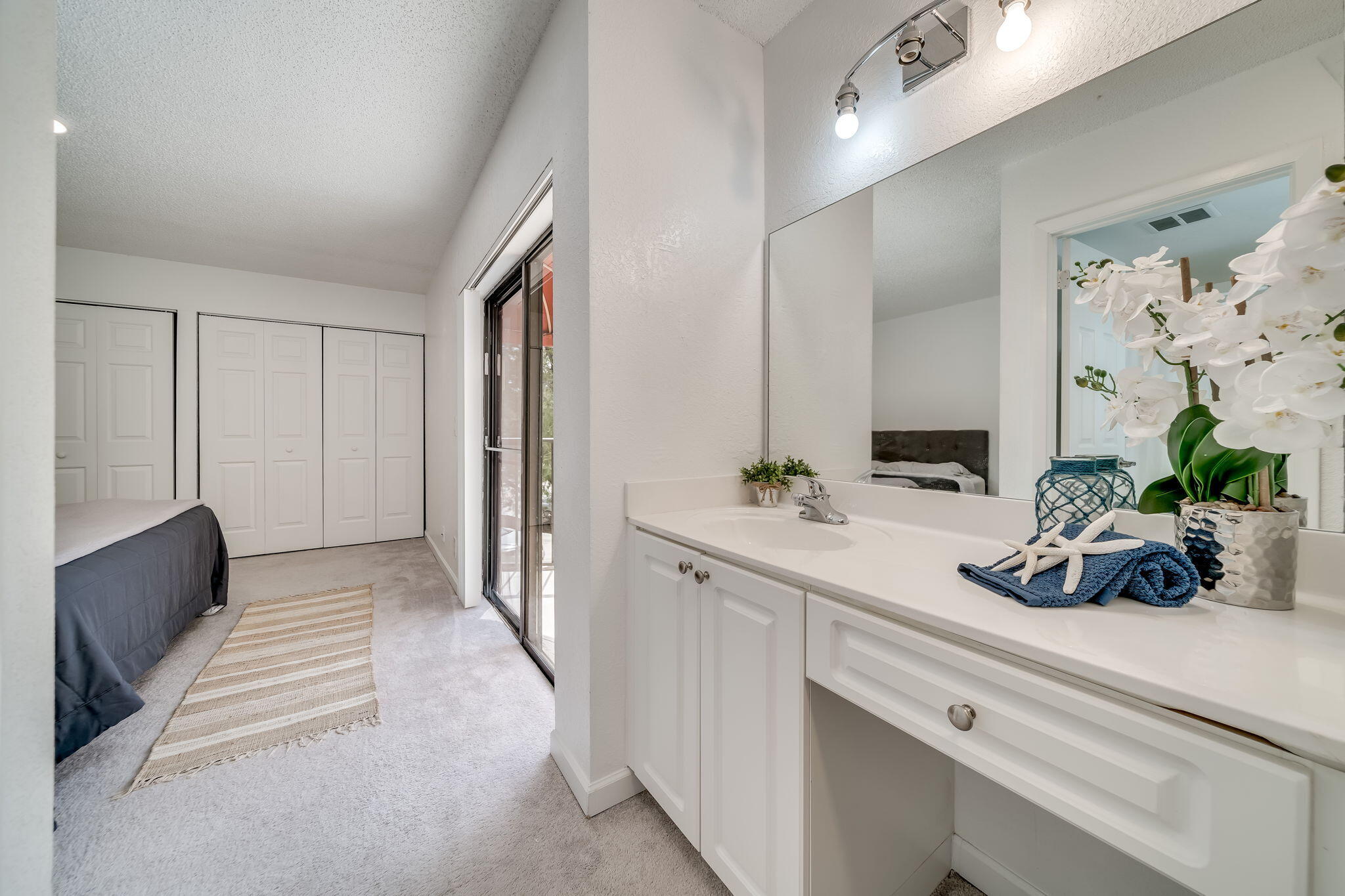 8116 Severn Drive, Unit C Boca Raton, FL 33433 - Photo 21 of 52 a bathroom with a double vanity sink and a mirror
