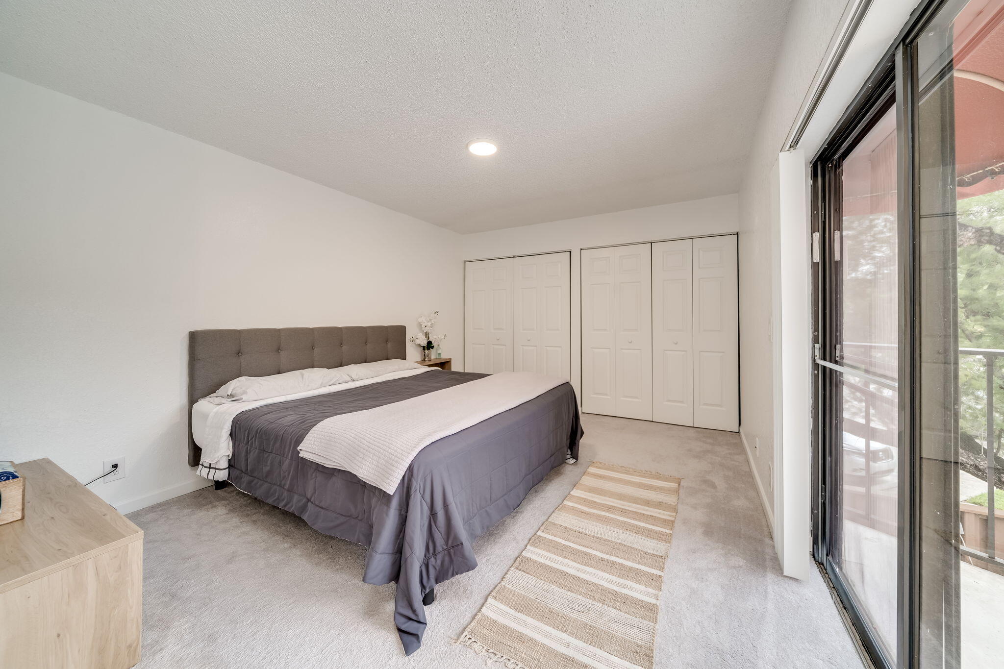 8116 Severn Drive, Unit C Boca Raton, FL 33433 - Photo 23 of 52 a spacious bedroom with a bed and a window