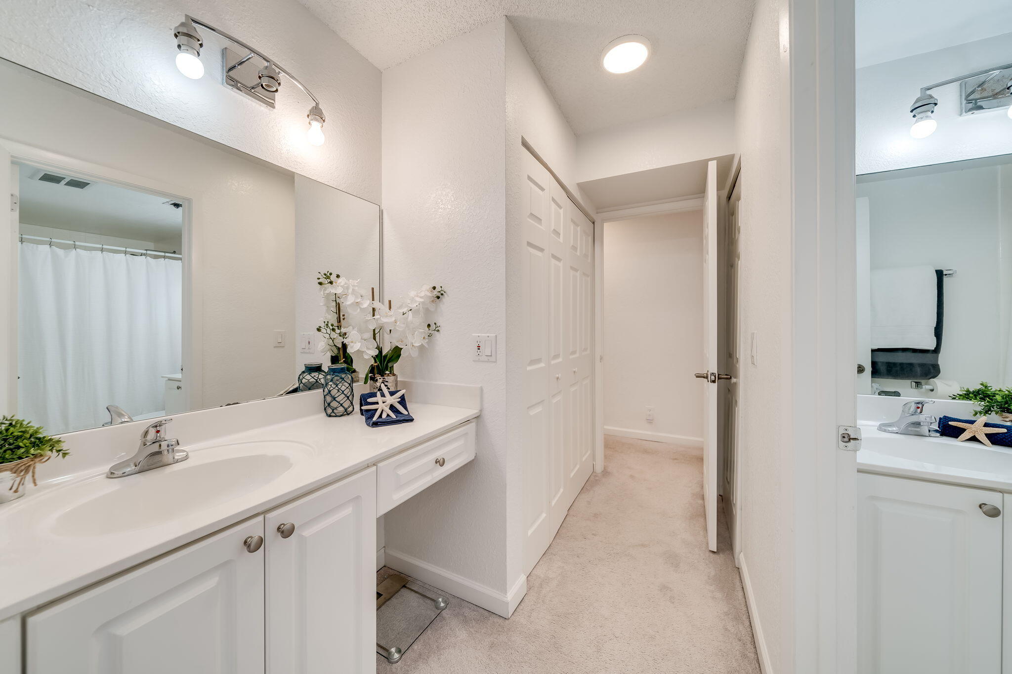 8116 Severn Drive, Unit C Boca Raton, FL 33433 - Photo 25 of 52 a bathroom with a sink vanity and a mirror