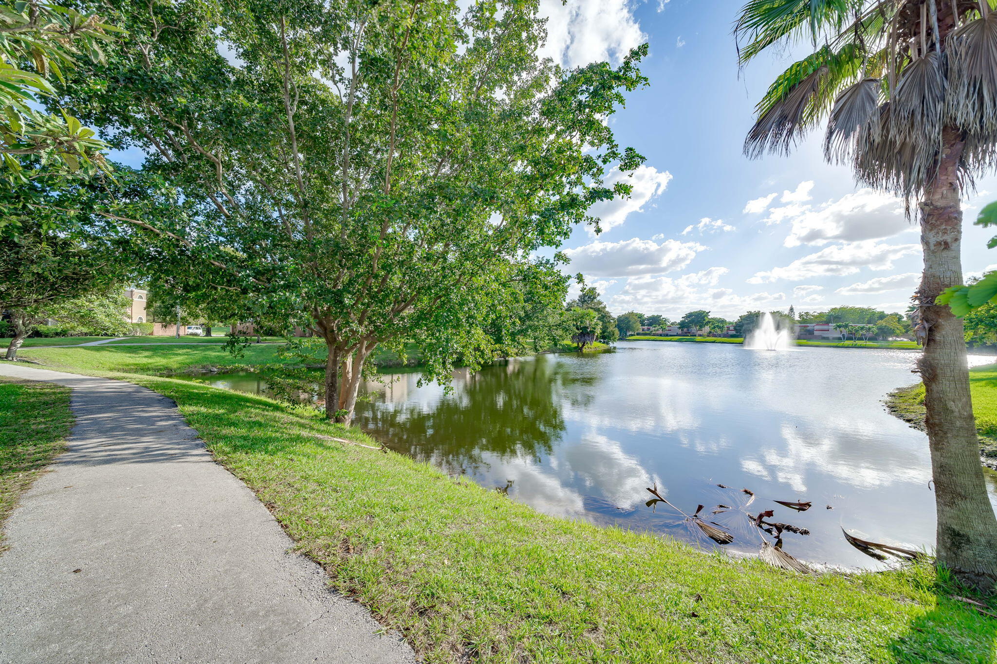 8116 Severn Drive, Unit C Boca Raton, FL 33433 - Photo 37 of 52 a view of a lake with a yard and potted plants