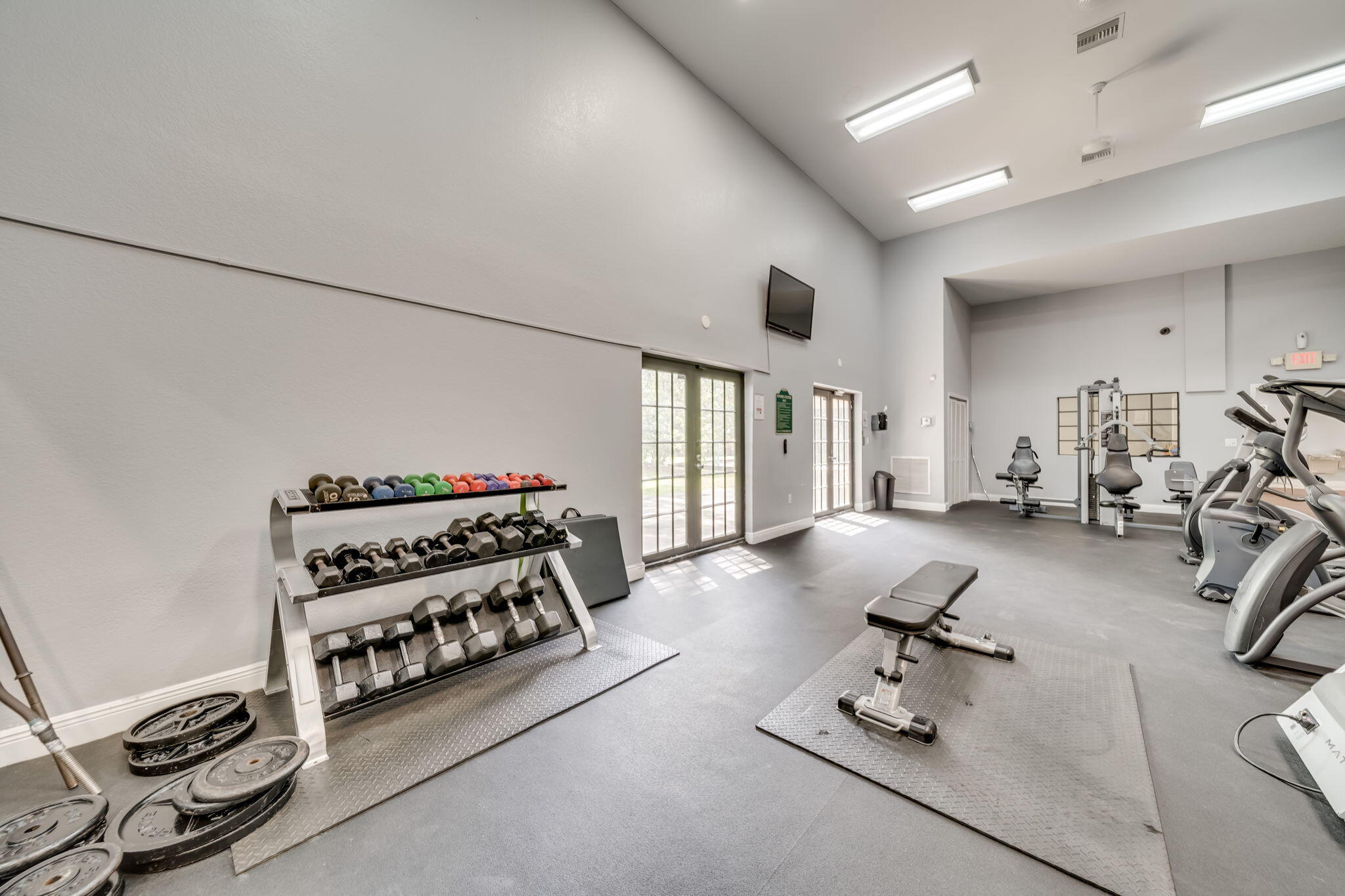 8116 Severn Drive, Unit C Boca Raton, FL 33433 - Photo 41 of 52 a room with gym equipment and a large window