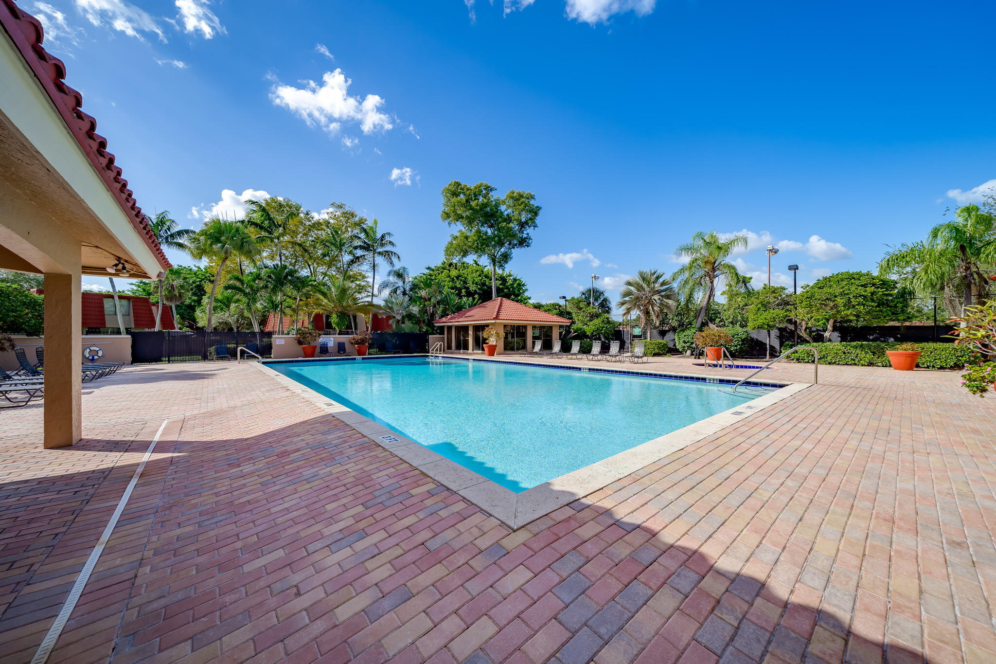 8116 Severn Drive, Unit C Boca Raton, FL 33433 - Photo 47 of 52 a view of a swimming pool with a yard