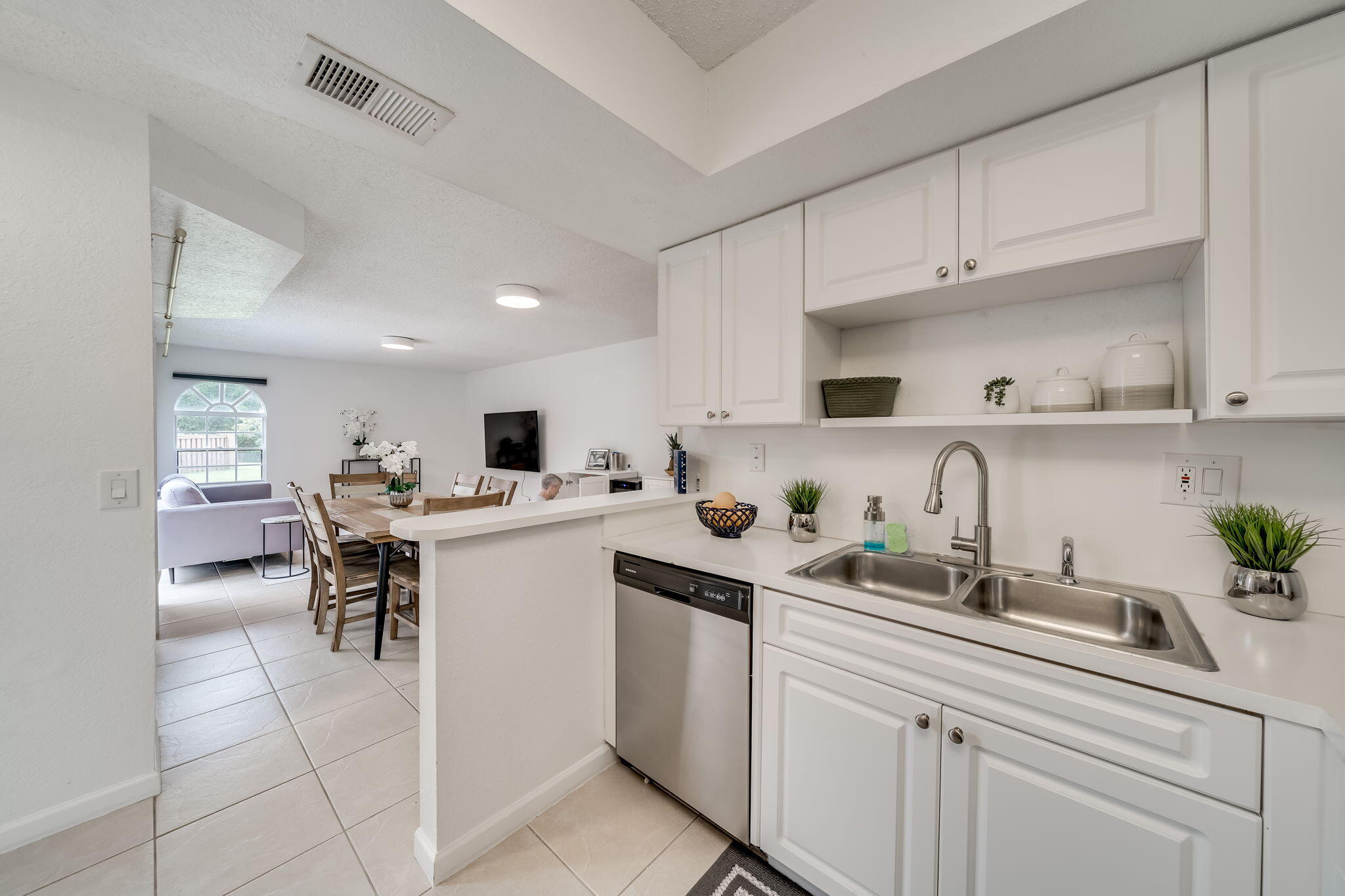 8116 Severn Drive, Unit C Boca Raton, FL 33433 - Photo 7 of 52 a kitchen with a sink white cabinets and white appliances