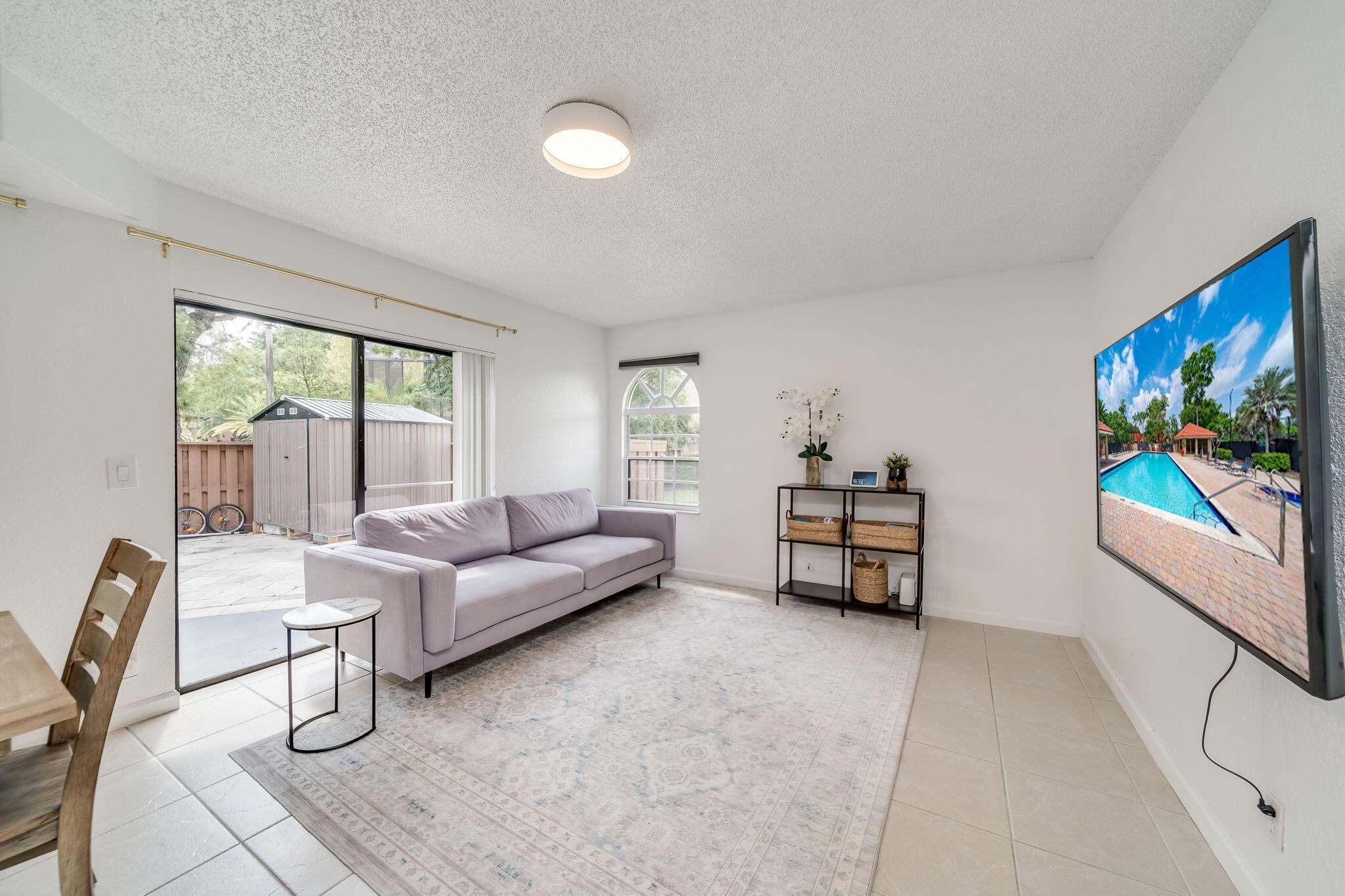 8116 Severn Drive, Unit C Boca Raton, FL 33433 - Photo 10 of 52 a living room with furniture and a flat screen tv