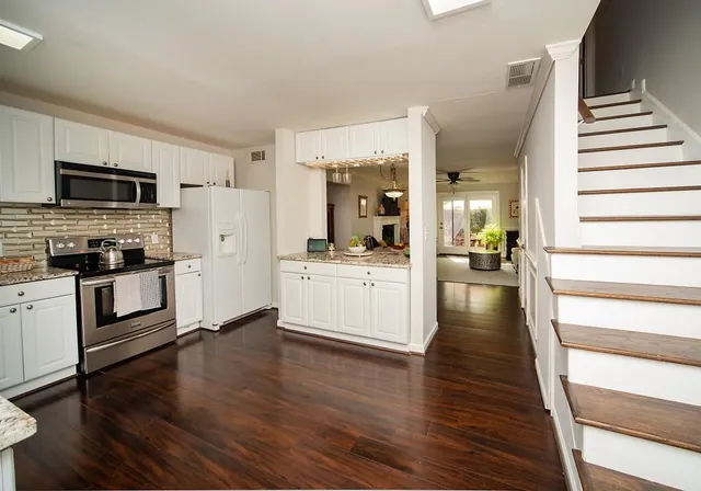 a kitchen with stainless steel appliances a white stove top oven and sink