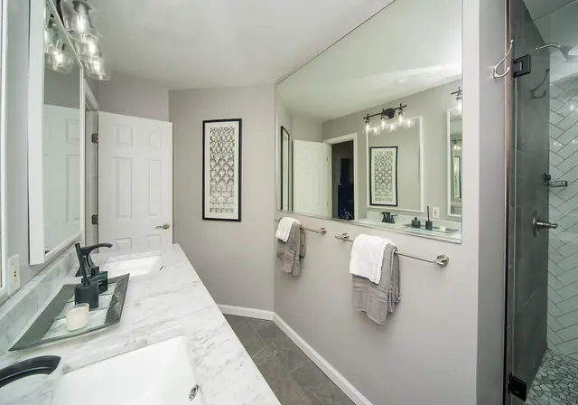 a bathroom with a tub sink and mirror