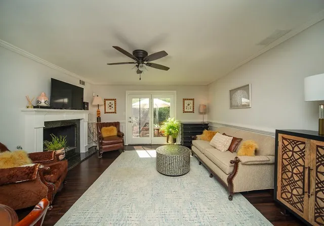a living room with furniture a flat screen tv and a fireplace