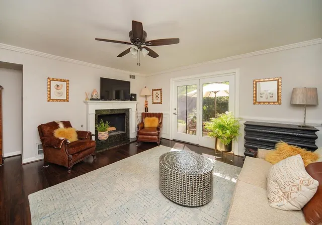 a living room with furniture a flat screen tv and a fireplace