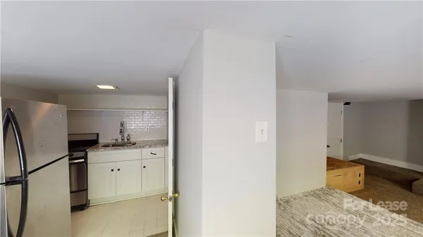 a kitchen with stainless steel appliances a refrigerator sink and cabinets