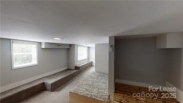 a view of an empty room and a window