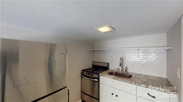 a kitchen with a stove and cabinets
