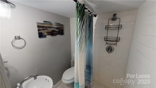 a bathroom with a toilet sink vanity and tub