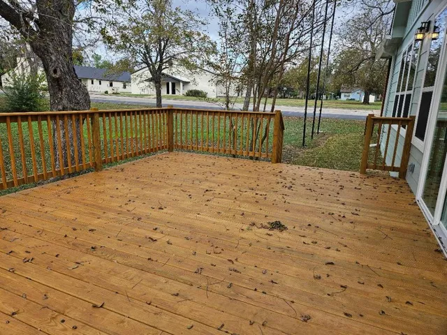 a view of backyard with wooden fence