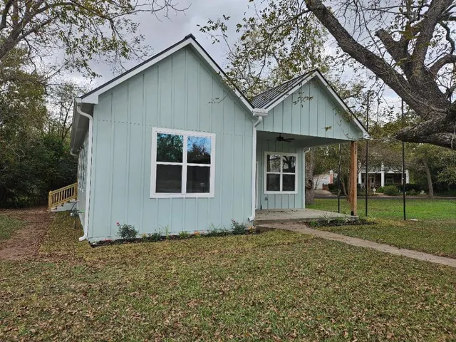a house with trees in the background