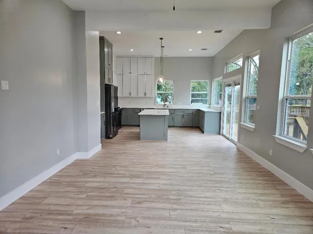 a view of kitchen with cabinets and wooden floor