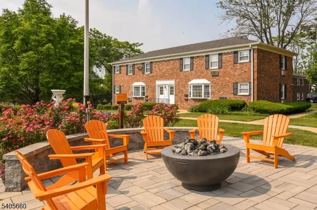 a front view of a house with patio furniture and garden