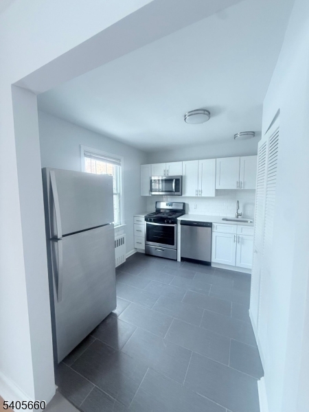 26 Locust Drive, Unit 47 Summit, NJ 07901 - Photo 6 of 12 a kitchen with stainless steel appliances a refrigerator sink and cabinets