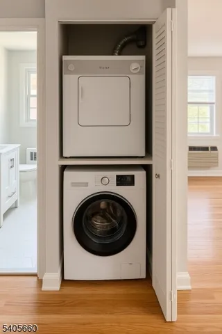 a utility room with wooden floor washer and dryer