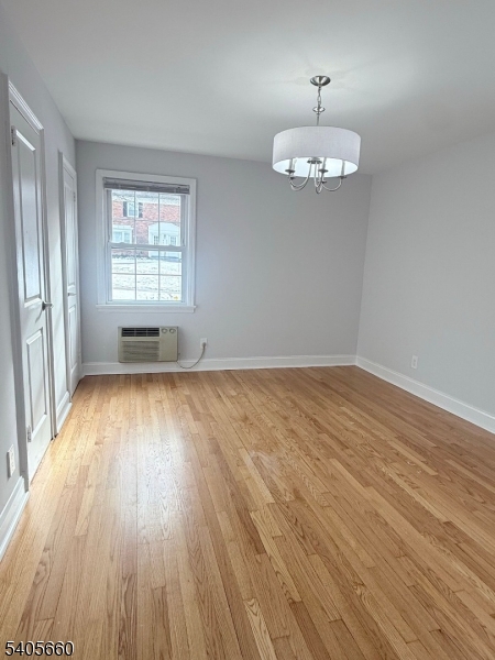 26 Locust Drive, Unit 47 Summit, NJ 07901 - Photo 10 of 12 an empty room with wooden floor and windows