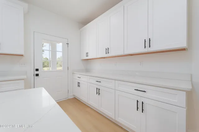 a kitchen with white cabinets and a sink