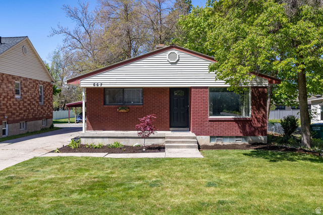 667 North 100 East Logan, UT 84321 - Photo 1 of 41 Legal duplex featuring a front lawn, brick siding, and driveway