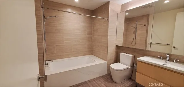 a bathroom with a tub toilet and sink