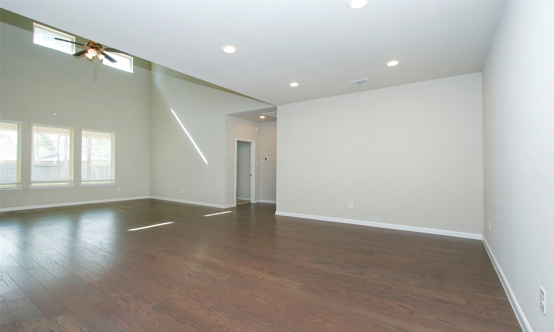 14120 Sand Ridge Court Conroe, TX 77384 - Photo 8 of 43 an empty room with wooden floor and windows