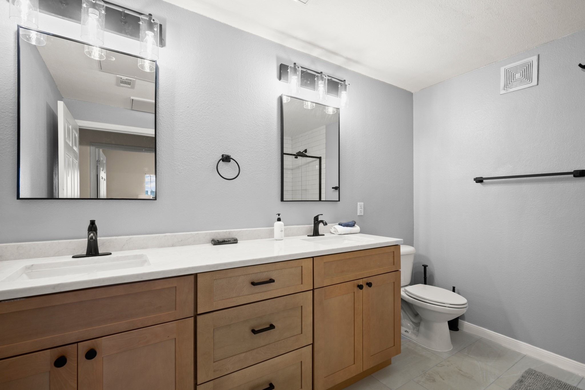2502 Leon Street, Unit 512 Austin, TX 78705 - Photo 13 of 27 The primary bathroom features an extended vanity with dual sinks and generous counter space.