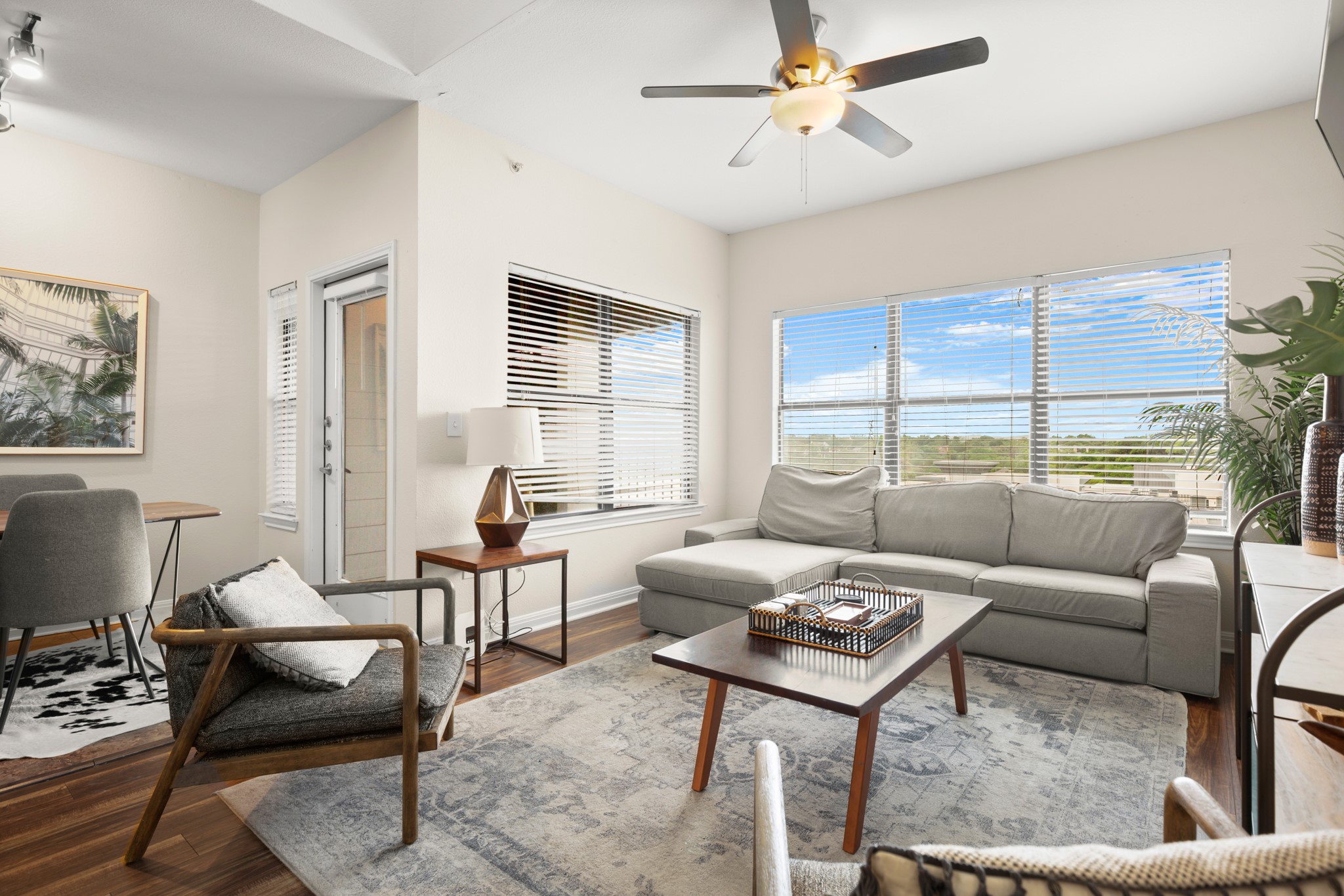 2502 Leon Street, Unit 512 Austin, TX 78705 - Photo 2 of 27 The bright living room features hardwood flooring and large windows that fill the space with natural light.