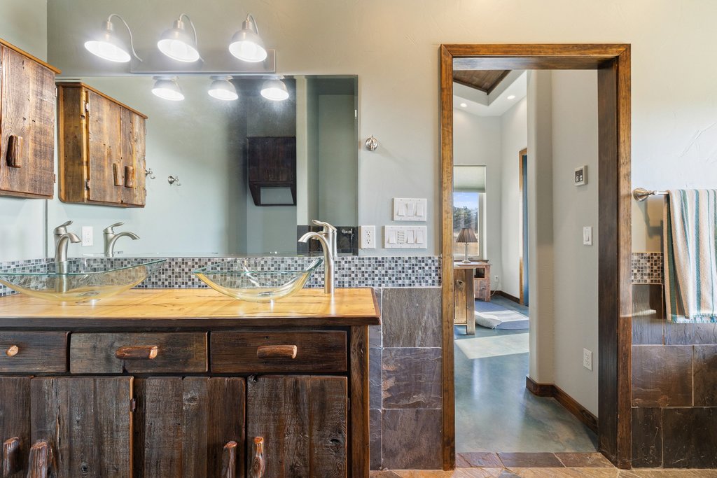 1292 Upper Turtle Creek Road Kerrville, TX 78028 - Photo 15 of 40 Full bath with double vanity and baseboards
