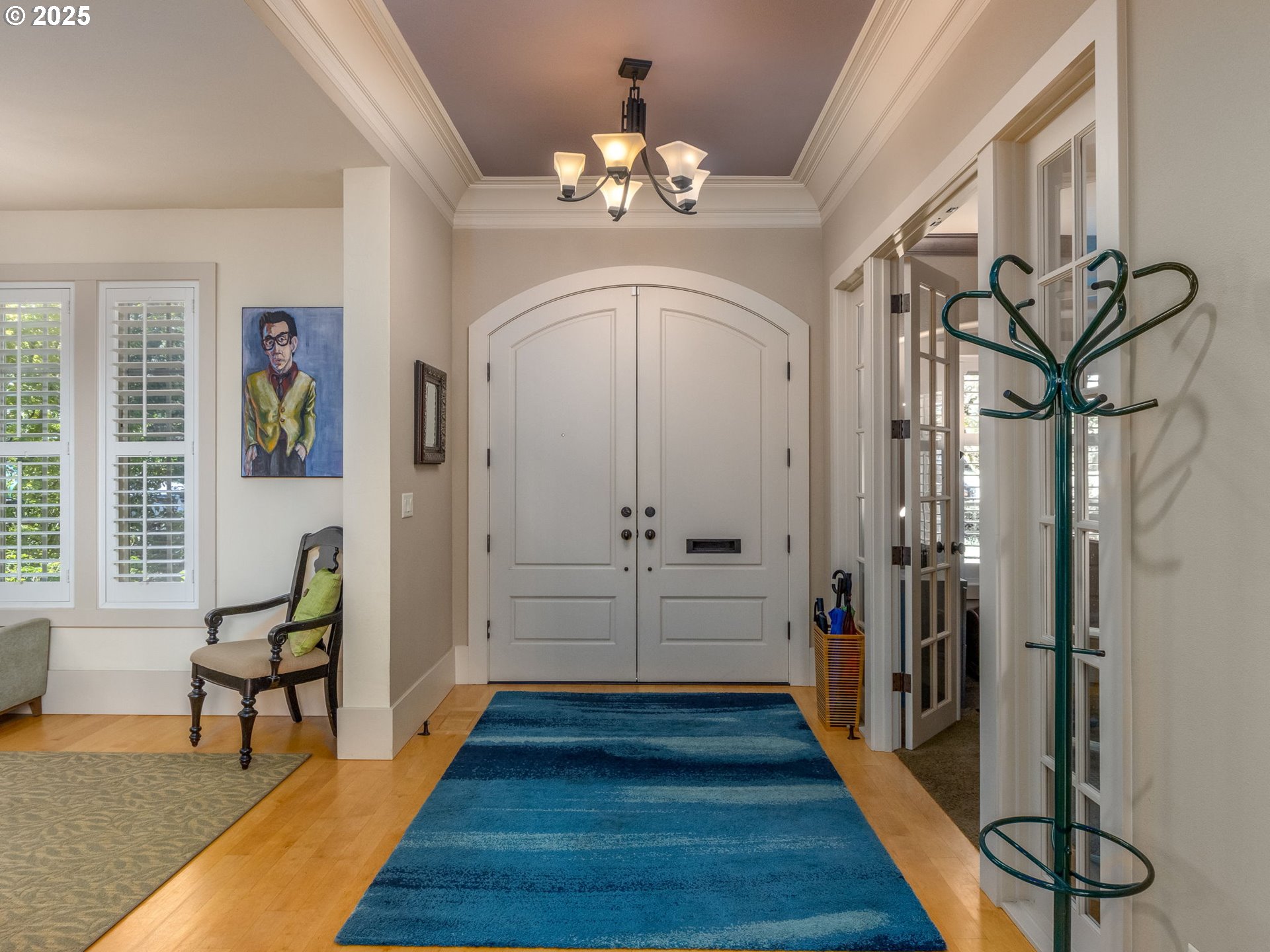 755 6th Street Lake Oswego, OR 97034 - Photo 3 of 48 a view of a hallway with wooden floor and a chandelier