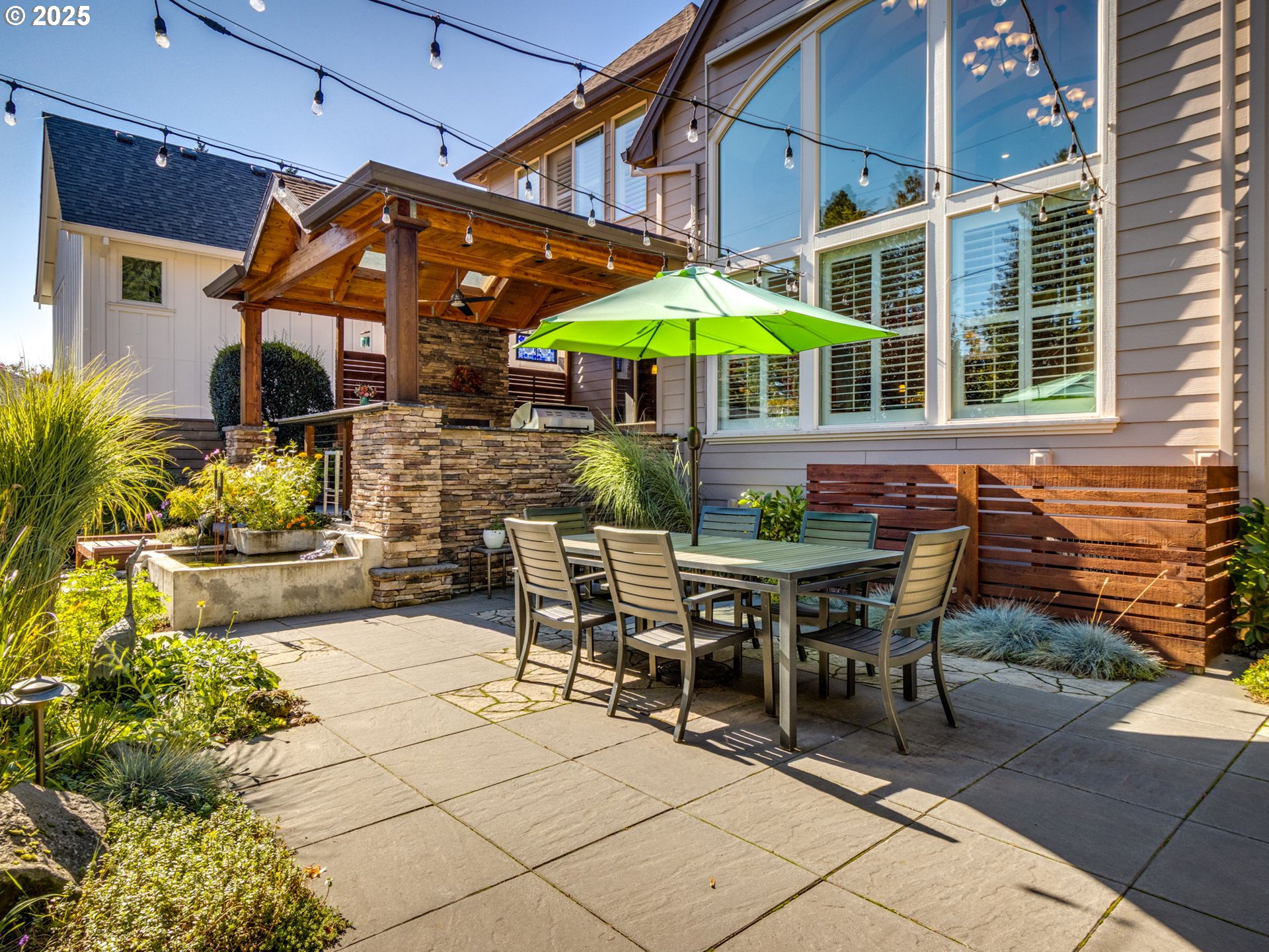 755 6th Street Lake Oswego, OR 97034 - Photo 36 of 48 a view of a patio with a table and chairs under an umbrella