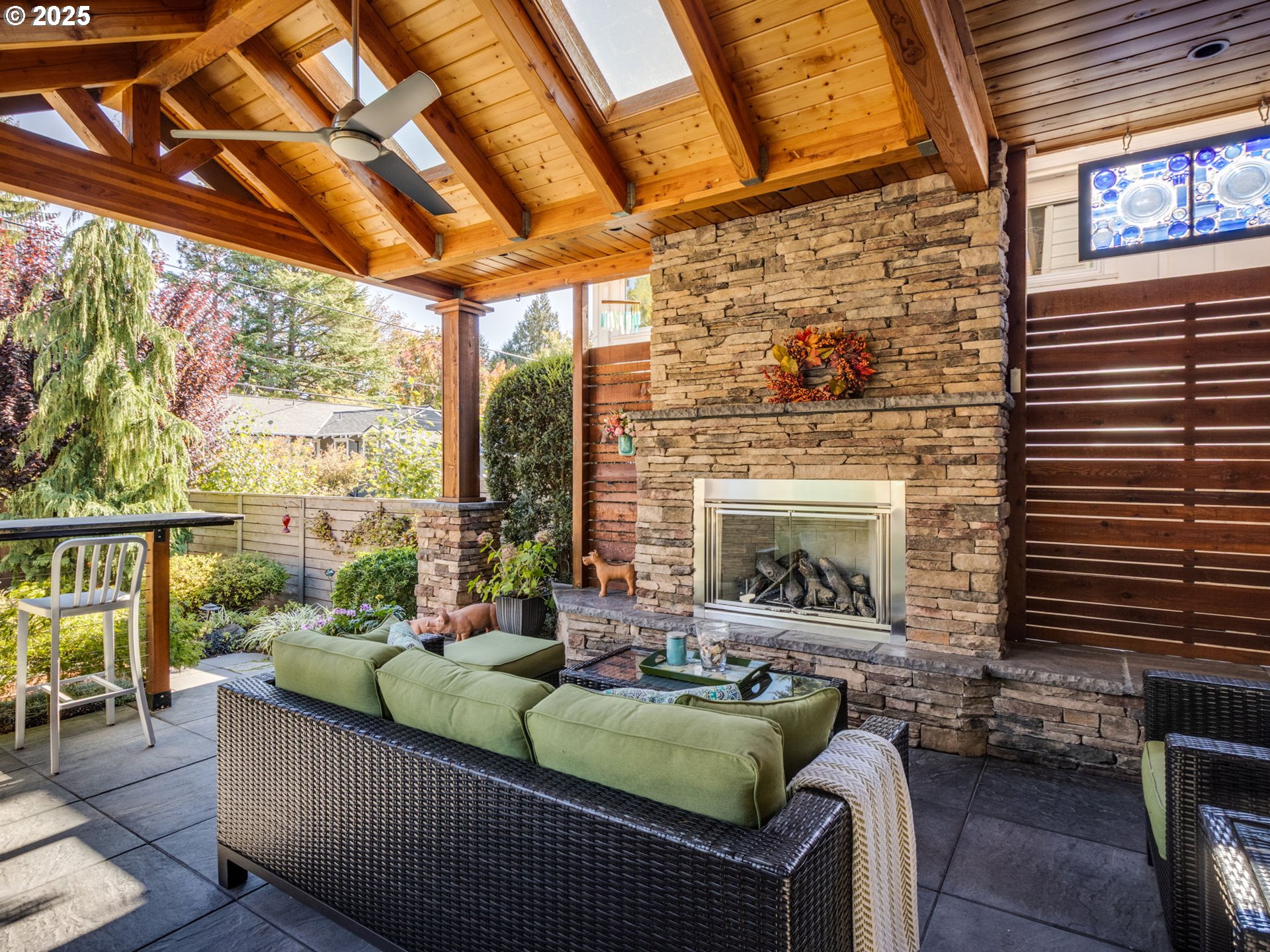 755 6th Street Lake Oswego, OR 97034 - Photo 42 of 48 a living room with furniture a fireplace and a floor to ceiling window