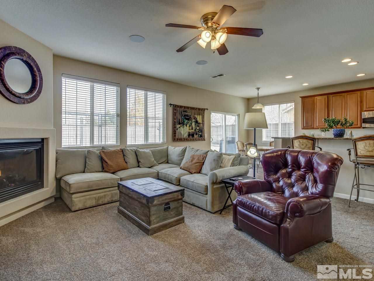 555 Little Sorrel Court Reno, NV 89521 - Photo 11 of 25 a living room with furniture a fireplace and a large window