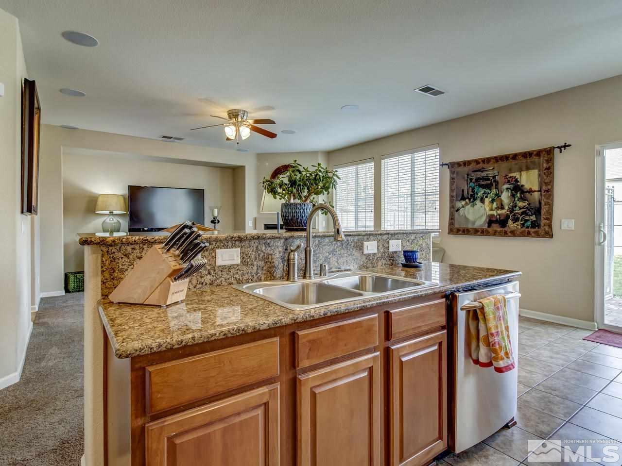555 Little Sorrel Court Reno, NV 89521 - Photo 4 of 25 a kitchen with stainless steel appliances granite countertop a sink and a refrigerator
