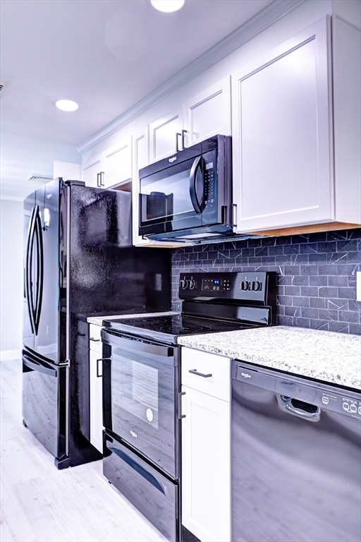8 Craig Road Chelmsford, MA 01824 - Photo 13 of 32 a kitchen with stainless steel appliances granite countertop a stove a sink and a microwave