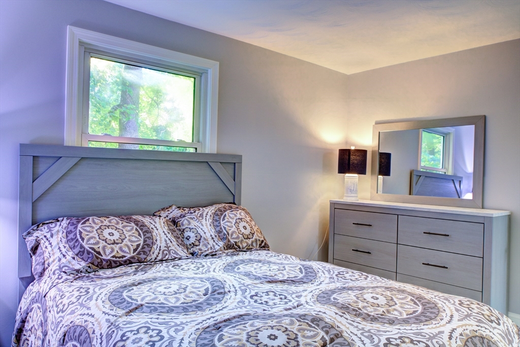 8 Craig Road Chelmsford, MA 01824 - Photo 19 of 32 a bedroom with a large bed and a dresser