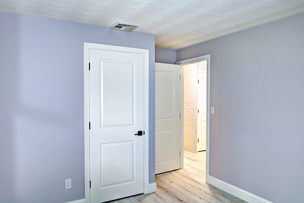 8 Craig Road Chelmsford, MA 01824 - Photo 23 of 32 a view of a hallway with wooden floor