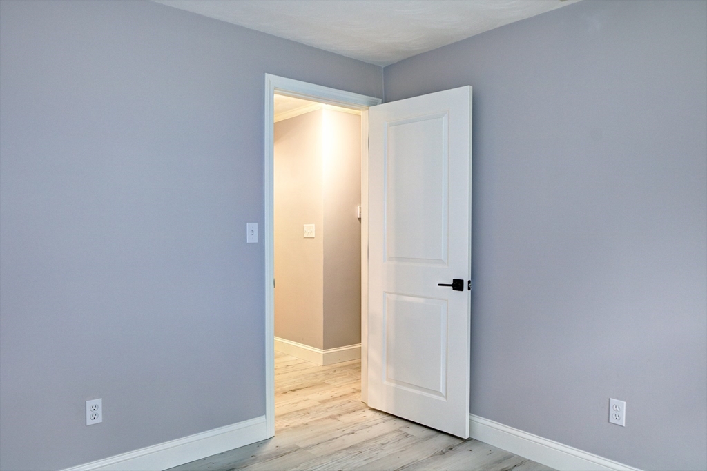 8 Craig Road Chelmsford, MA 01824 - Photo 26 of 32 a view of an empty room with wooden floor and a window