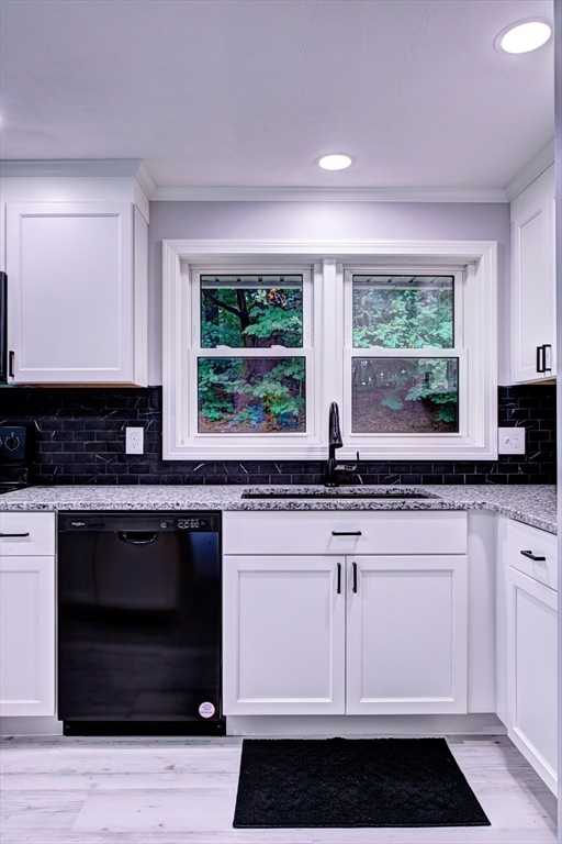 8 Craig Road Chelmsford, MA 01824 - Photo 10 of 32 a kitchen with stainless steel appliances granite countertop a stove and a white cabinets