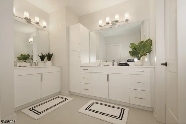 a bathroom with a sink vanity and a mirror