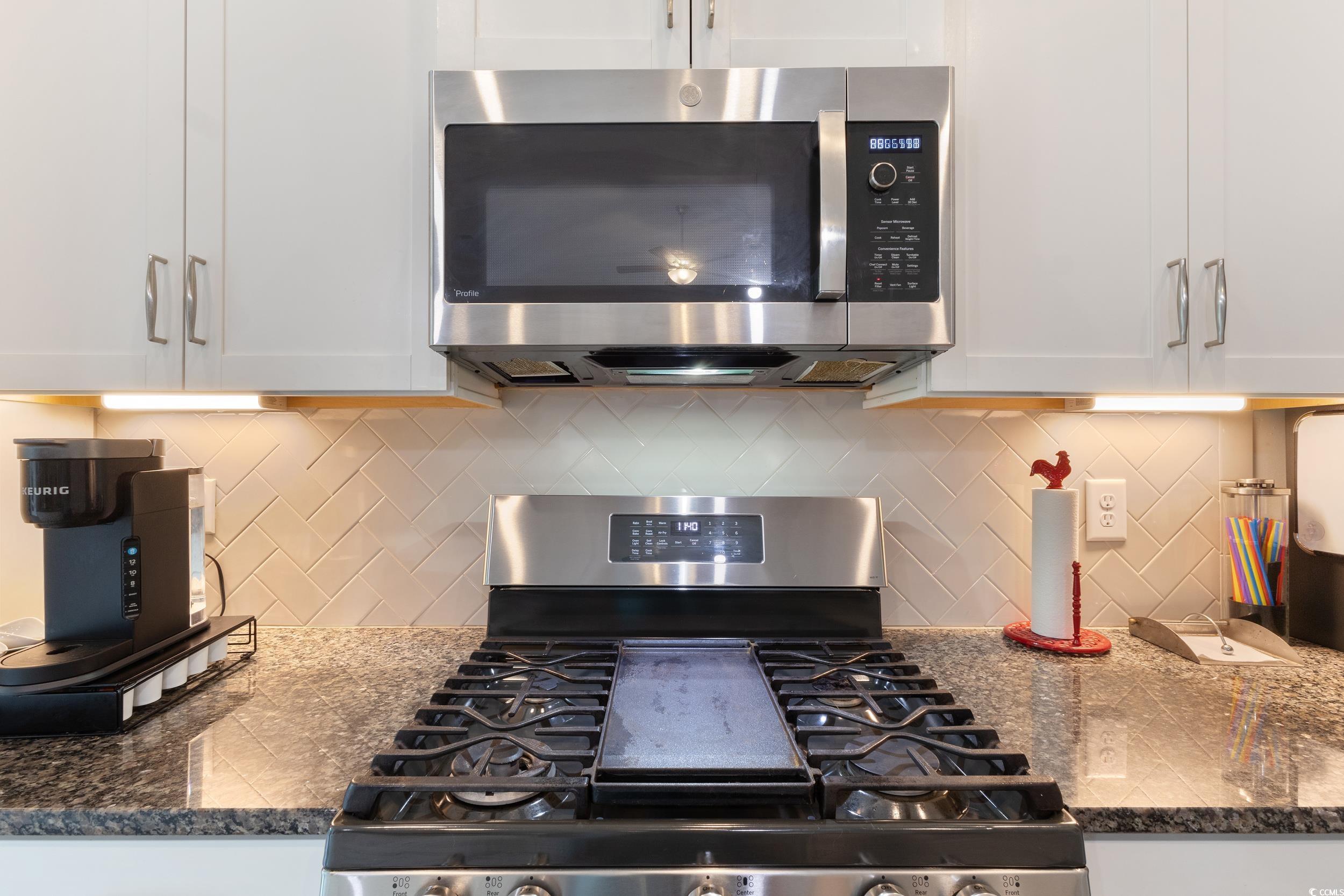 540 Canborough Lane Murrells Inlet, SC 29576 - Photo 16 of 40 Kitchen featuring stainless steel appliances, backsplash, dark stone countertops, and white cabinets
