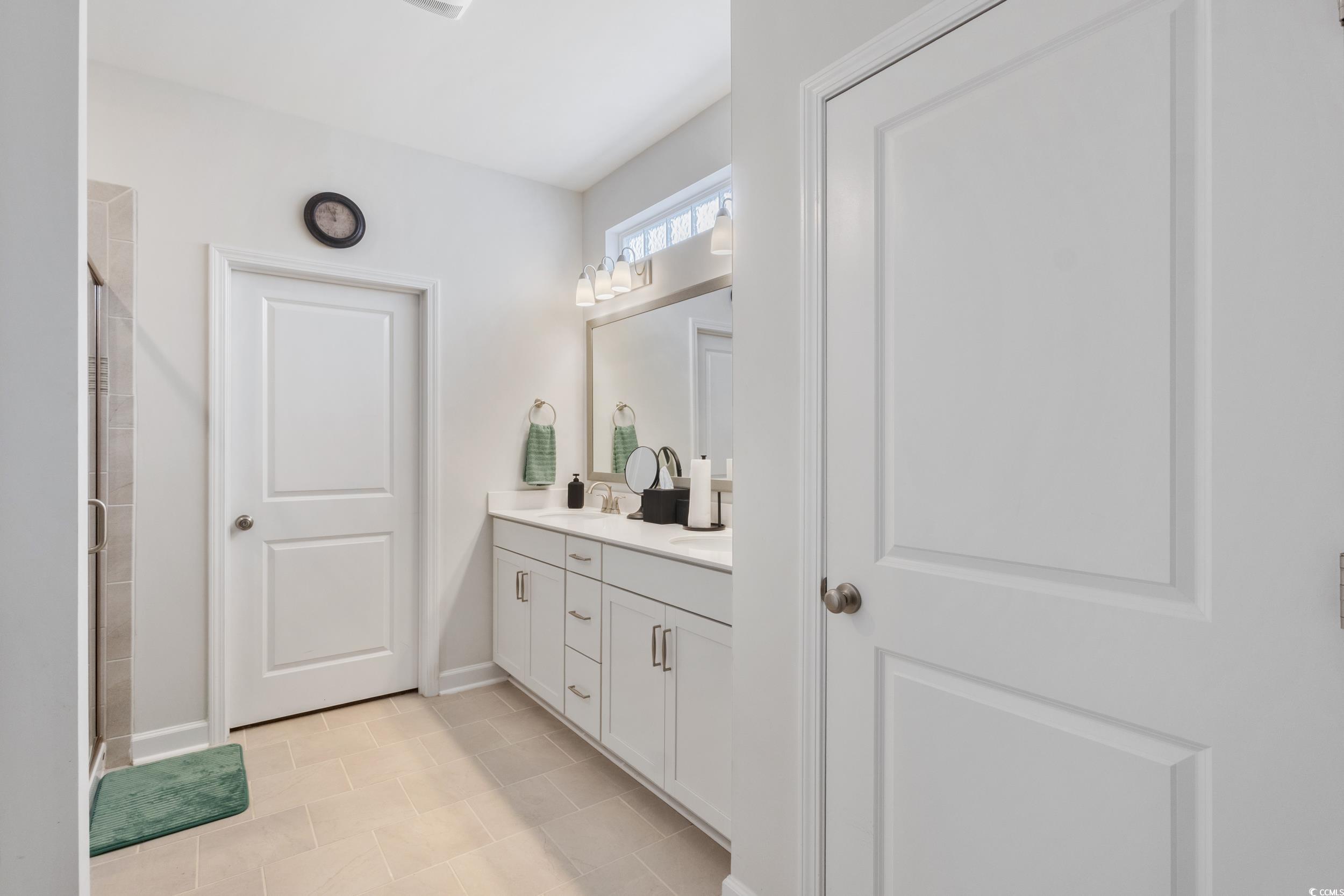 540 Canborough Lane Murrells Inlet, SC 29576 - Photo 24 of 40 Bathroom featuring double vanity, a shower stall, and light tile patterned floors