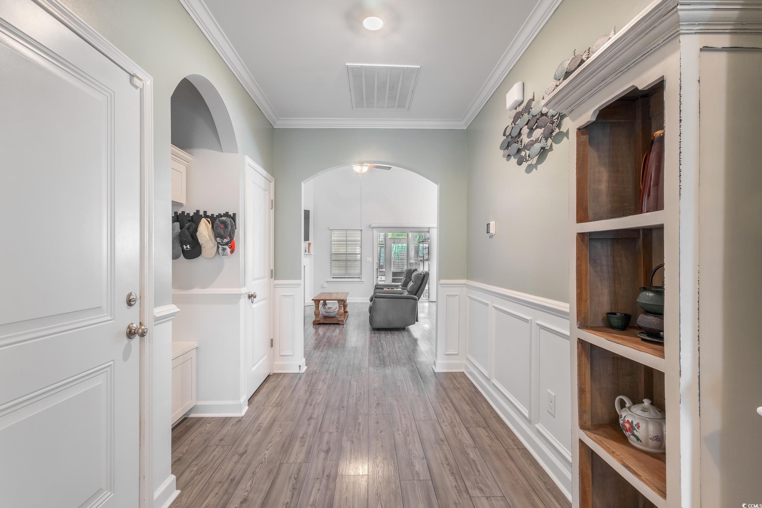 540 Canborough Lane Murrells Inlet, SC 29576 - Photo 6 of 40 Hall featuring arched walkways, ornamental molding, light wood-style flooring, wainscoting, and a decorative wall