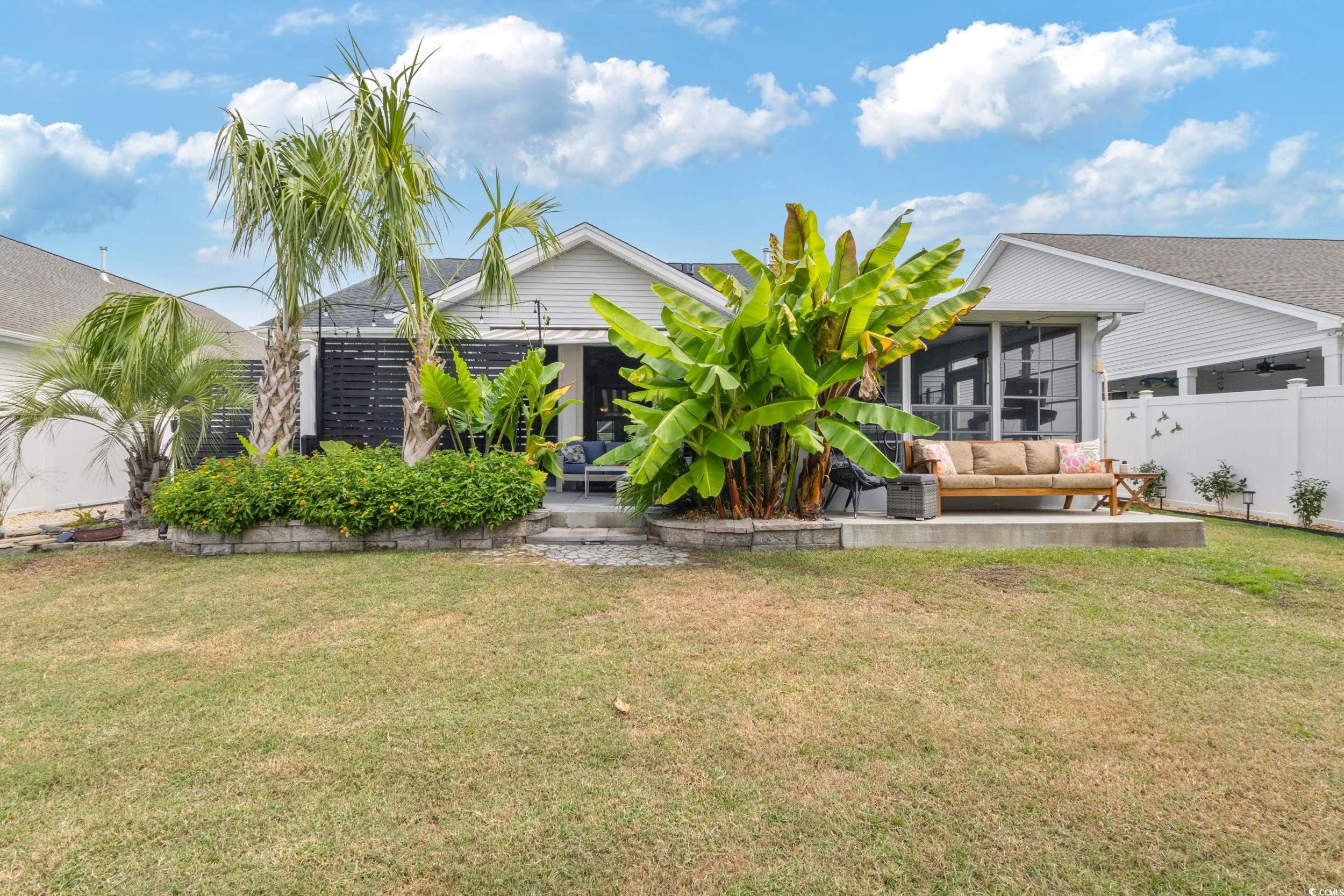 540 Canborough Lane Murrells Inlet, SC 29576 - Photo 9 of 40 Back of property featuring a sunroom and a patio area