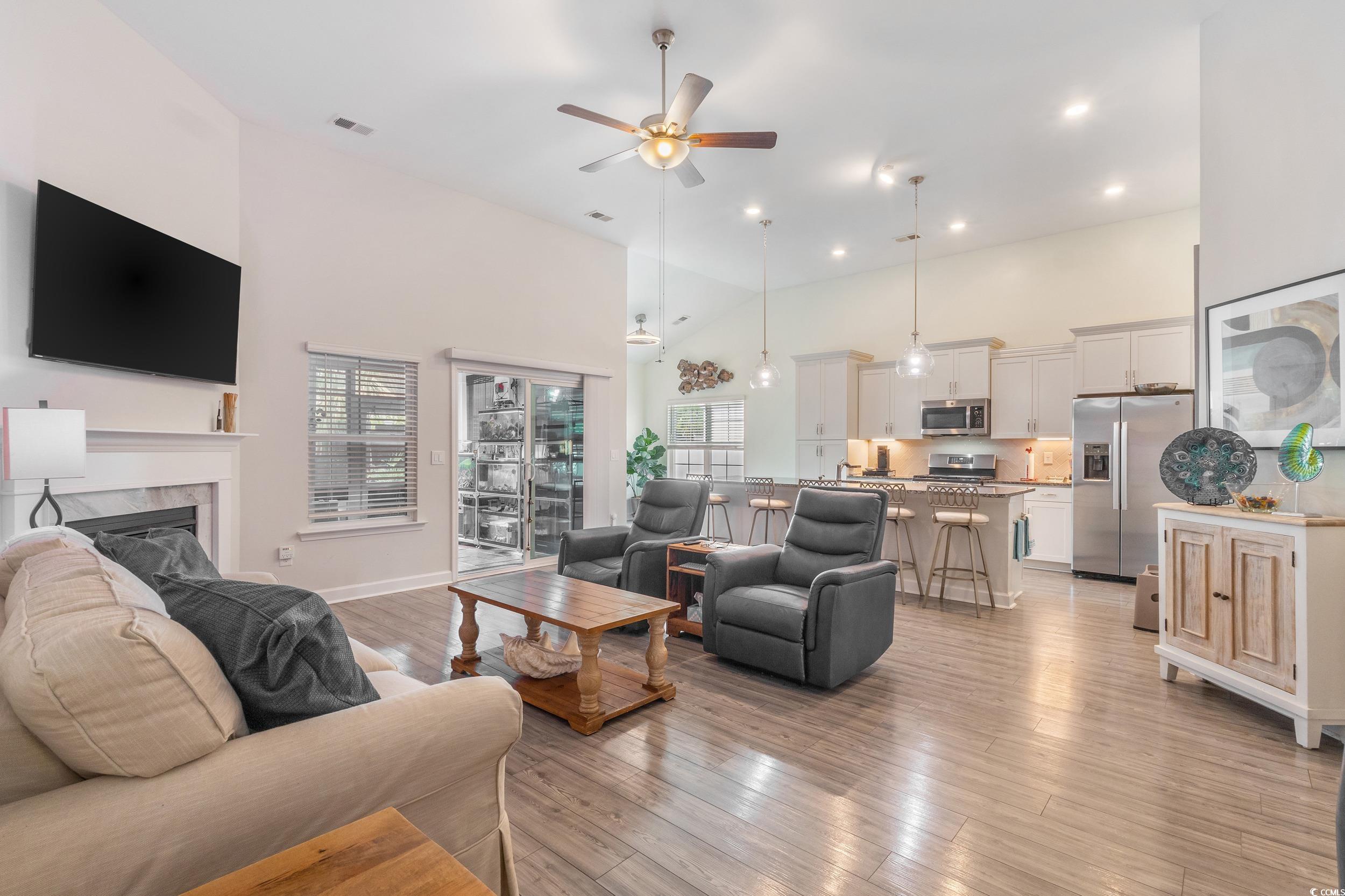 540 Canborough Lane Murrells Inlet, SC 29576 - Photo 10 of 40 Living room featuring a ceiling fan, a high ceiling, light wood finished floors, a high end fireplace, and recessed lighting