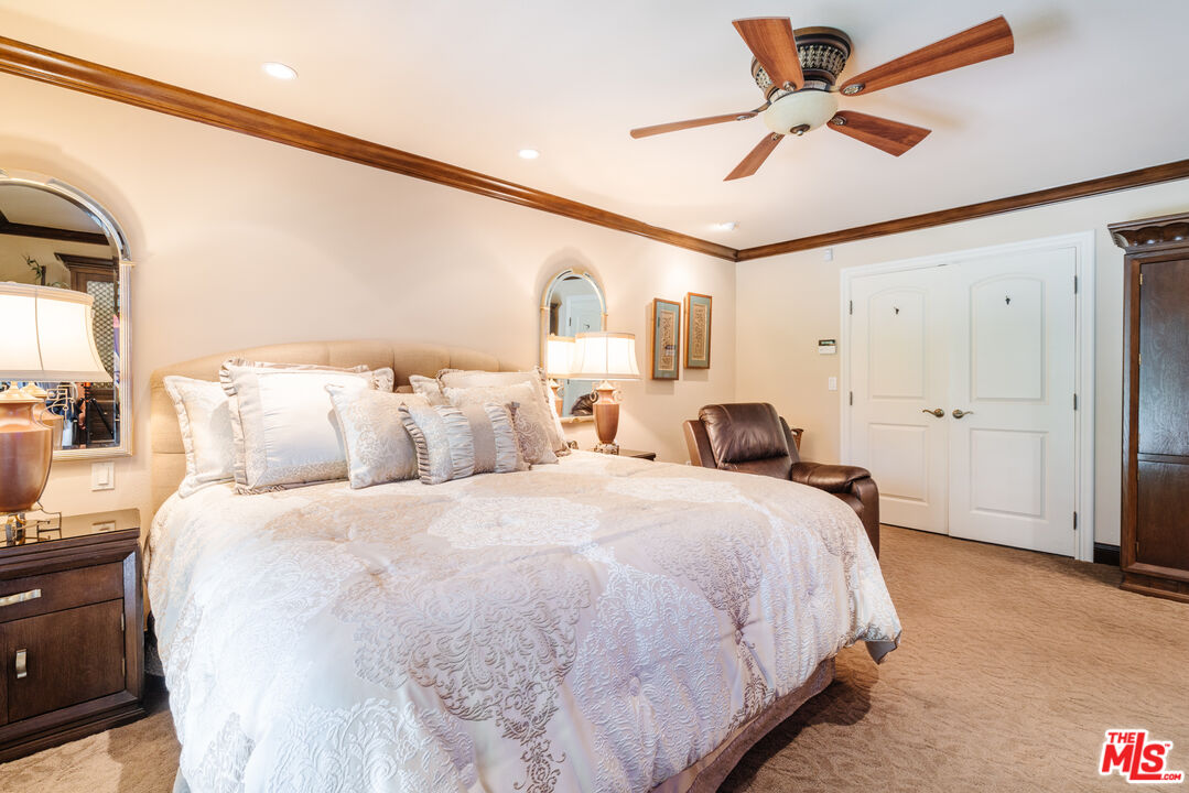 17835 Lemarsh Street Northridge, CA 91325 - Photo 24 of 41 a large bedroom with bed and a chandelier